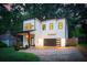 Charming two-story home showcasing its modern design, curb appeal, a garage, and a well-manicured lawn at 156 Martha Ne Ave, Atlanta, GA 30317