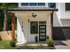 Inviting front porch with modern door, decorative plants, and a stylish ceiling fan at 156 Martha Ne Ave, Atlanta, GA 30317