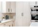 Bright kitchen featuring white cabinets, stainless steel appliances, and quartz countertops at 156 Martha Ne Ave, Atlanta, GA 30317