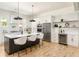 Modern kitchen with stainless steel appliances, a large island, and open shelving at 156 Martha Ne Ave, Atlanta, GA 30317