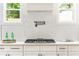 Modern kitchen features a gas cooktop, stylish backsplash, and bright windows at 156 Martha Ne Ave, Atlanta, GA 30317