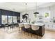 Open concept kitchen featuring a large island, modern lighting, and a dining area at 156 Martha Ne Ave, Atlanta, GA 30317