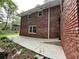 Brick home exterior featuring a concrete patio area and garden landscaping at 2429 Sherbrooke Ne Ct, Atlanta, GA 30345