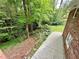 Brick home featuring a concrete patio next to a lush green backyard with mature trees and shade at 2429 Sherbrooke Ne Ct, Atlanta, GA 30345