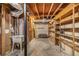 Unfinished basement area with open rafters, utility sink, and ample storage shelving at 2429 Sherbrooke Ne Ct, Atlanta, GA 30345
