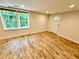 Finished basement room featuring wood-look tile flooring, natural light, and an exterior door at 2429 Sherbrooke Ne Ct, Atlanta, GA 30345