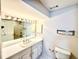 Bright bathroom featuring a large vanity, sink, and a well-lit mirror with classic fixtures at 2429 Sherbrooke Ne Ct, Atlanta, GA 30345