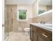 Bathroom showcasing a glass-door shower, double vanity, and neutral tile at 2429 Sherbrooke Ne Ct, Atlanta, GA 30345