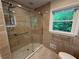Bright bathroom features a walk-in shower and large window with a wooded view at 2429 Sherbrooke Ne Ct, Atlanta, GA 30345