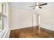 Bright, airy bedroom with hardwood floors, ceiling fan, and a large window at 2429 Sherbrooke Ne Ct, Atlanta, GA 30345