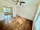 Sunlit bedroom with hardwood floors, ceiling fan, and mirrored closet doors at 2429 Sherbrooke Ne Ct, Atlanta, GA 30345