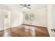 Bright bedroom with hardwood floors, a ceiling fan, and an attached bathroom at 2429 Sherbrooke Ne Ct, Atlanta, GA 30345