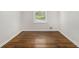 Bright bedroom featuring a large window overlooking the front yard and hardwood floors at 2429 Sherbrooke Ne Ct, Atlanta, GA 30345