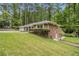 Brick home on a well-manicured and gently sloping lawn with surrounding mature trees at 2429 Sherbrooke Ne Ct, Atlanta, GA 30345