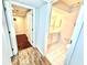 Inviting hallway featuring access to a well-lit bathroom and a room with rich hardwood flooring at 2429 Sherbrooke Ne Ct, Atlanta, GA 30345