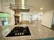 View from kitchen island showing granite countertop, stainless steel vent, and living room beyond at 2429 Sherbrooke Ne Ct, Atlanta, GA 30345