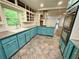 Well-lit kitchen featuring vibrant cabinetry, tile floor, and stainless steel appliances at 2429 Sherbrooke Ne Ct, Atlanta, GA 30345