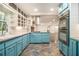 Open kitchen with stainless steel appliances, custom cabinets, and tile floors at 2429 Sherbrooke Ne Ct, Atlanta, GA 30345