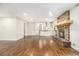 Spacious living room with hardwood floors, a stone fireplace, and an open view to the kitchen at 2429 Sherbrooke Ne Ct, Atlanta, GA 30345