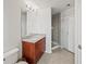 Bathroom featuring a granite countertop, vanity, walk-in shower with glass door, and modern fixtures at 361 17Th Nw St # 1222, Atlanta, GA 30363