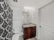 Well-lit bathroom with granite countertop, modern vanity, toilet, and patterned shower curtain at 361 17Th Nw St # 1222, Atlanta, GA 30363
