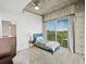 Bright bedroom featuring a ceiling fan, concrete ceiling, and a large window offering city views at 361 17Th Nw St # 1222, Atlanta, GA 30363