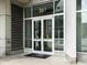 Modern building entrance featuring glass doors, a visible unit number, and architectural details at 361 17Th Nw St # 1222, Atlanta, GA 30363