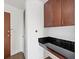 Practical laundry area with dark wood cabinets, sink and backsplash at 361 17Th Nw St # 1222, Atlanta, GA 30363
