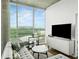 Comfortable living room with a large window, couch and modern entertainment center at 361 17Th Nw St # 1222, Atlanta, GA 30363