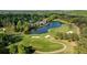 Picturesque aerial view of a lush golf course with a scenic lake and upscale homes nestled amidst the verdant landscape at 5625 Buckleigh Pointe, Suwanee, GA 30024