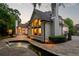 Beautiful backyard view featuring a luxurious pool, stone patio, and manicured landscaping against a picturesque home exterior at 5625 Buckleigh Pointe, Suwanee, GA 30024