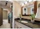 Well-appointed bathroom features a granite vanity, undermount sink, and closet access at 5625 Buckleigh Pointe, Suwanee, GA 30024