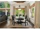 Bright dining area features beautiful windows, stylish light fixture, and views of the landscaped yard at 5625 Buckleigh Pointe, Suwanee, GA 30024