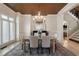 Formal dining room features custom lighting, neutral walls, and seating for six at 5625 Buckleigh Pointe, Suwanee, GA 30024