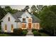 Stunning white home featuring manicured landscaping, arched windows, and a classic design at 5625 Buckleigh Pointe, Suwanee, GA 30024