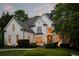 Elegant home exterior with manicured landscaping, architectural details, and warm, inviting lighting creating a luxurious curb appeal at 5625 Buckleigh Pointe, Suwanee, GA 30024