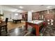 Recreational room featuring a pool table and air hockey, complemented by unique wall art and a cozy atmosphere at 5625 Buckleigh Pointe, Suwanee, GA 30024