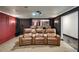 Home theater room with leather recliners, projector and movie screen, and a dark color scheme for an immersive experience at 5625 Buckleigh Pointe, Suwanee, GA 30024