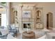 Cozy living room with a fireplace, custom built-ins, and ample natural light at 5625 Buckleigh Pointe, Suwanee, GA 30024