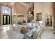 Inviting living room with soaring ceilings, grand staircase, and decorative chandelier at 5625 Buckleigh Pointe, Suwanee, GA 30024