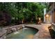 Scenic pool area with cascading waterfall, stone accents, and well-manicured landscaping, providing a serene oasis at 5625 Buckleigh Pointe, Suwanee, GA 30024
