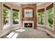 Cozy sitting room with a fireplace and lots of natural light, perfect for relaxing or reading a book at 5625 Buckleigh Pointe, Suwanee, GA 30024