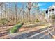 The backyard is landscaped with decorative rocks and overlooks a densely wooded area at 239 Trail Nw Rd, Marietta, GA 30064