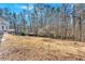 A view of the large backyard is partially wooded and open at 239 Trail Nw Rd, Marietta, GA 30064
