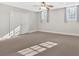 Spacious carpeted basement with neutral walls, natural light, and ceiling fan at 239 Trail Nw Rd, Marietta, GA 30064
