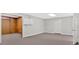 Partially finished basement with wood paneled walls and a view to a finished area at 239 Trail Nw Rd, Marietta, GA 30064
