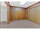 Cozy basement with wood paneled walls and neutral carpeting at 239 Trail Nw Rd, Marietta, GA 30064