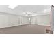 Finished basement with a brick fireplace, drop ceiling, recessed lights, and multiple doors for easy access at 239 Trail Nw Rd, Marietta, GA 30064
