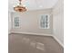 Finished basement space featuring a modern chandelier and ample natural light at 239 Trail Nw Rd, Marietta, GA 30064