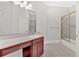 Bathroom with vanity, mirror, shower with glass door, and tile flooring at 239 Trail Nw Rd, Marietta, GA 30064